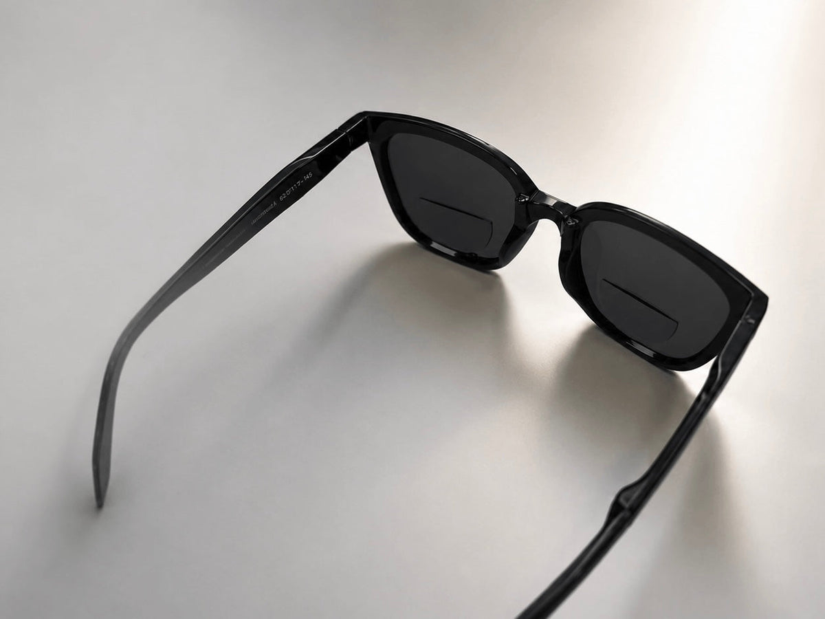 Black sunglasses with stick-on bifocal lenses for reading and distance vision