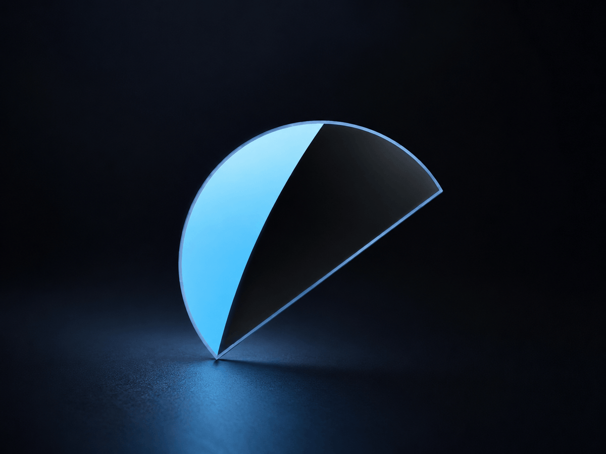 Close-up of a transparent stick-on reading lens with a blue-tinted edge, shown against a dark background to highlight its thin, curved shape.