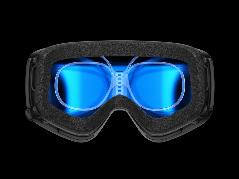 Clear prescription goggle insert fitted inside black sports goggles for comparison with traditional prescription glasses.