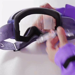 Clear prescription goggle insert being positioned inside a pair of sports goggles. The insert fits securely behind the goggle lens for vision correction without wearing regular glasses.