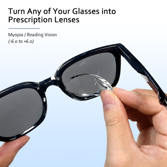 A hand applies a clear stick on prescription lens to the inside of dark sunglasses for myopia correction. Text reads "Turn Any of Your Glasses into Prescription Lenses". "Myopia / Reading Vision". "(-6.0 to +6.0)".