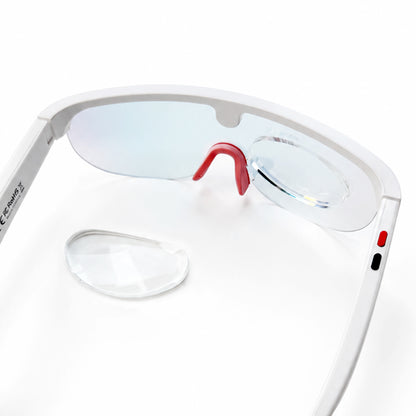 Clear stick on reading lens attached to white ai glasses with a second lens placed beside them.