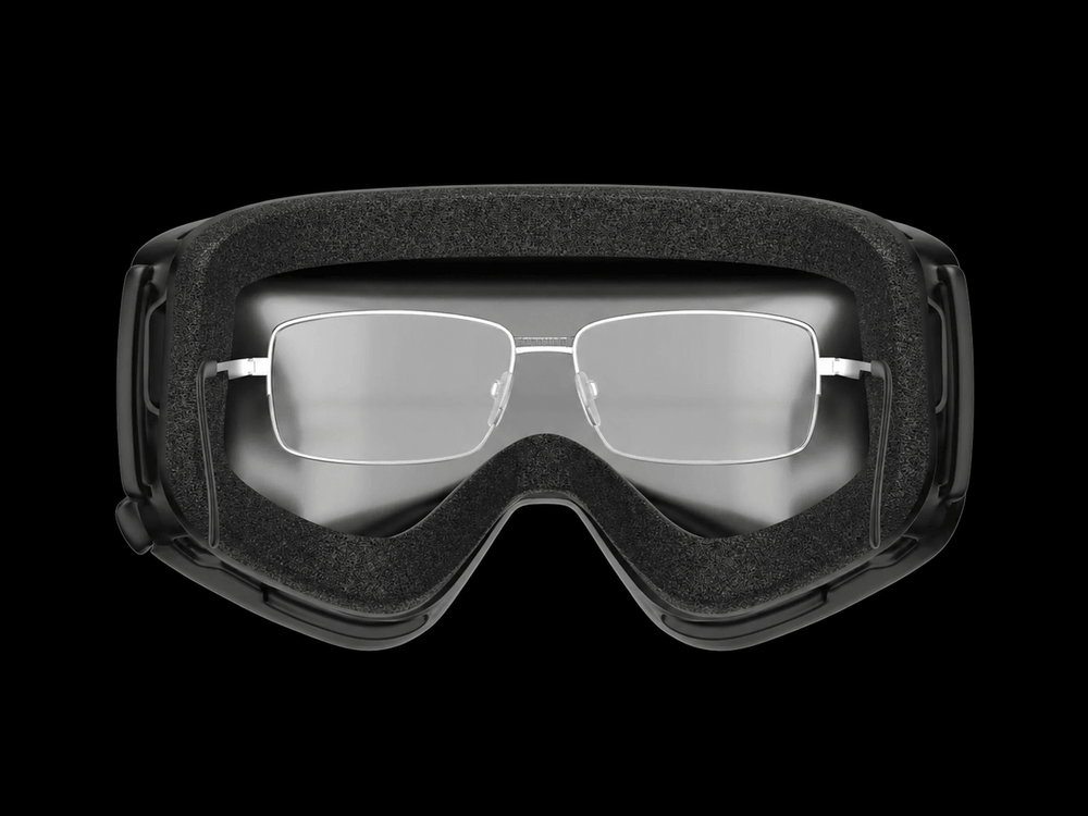 Traditional prescription glasses worn inside black sports goggles for comparison with prescription goggle inserts.